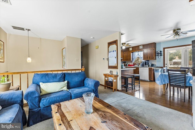 living room featuring ceiling fan and light hardwood / wood-style flooring