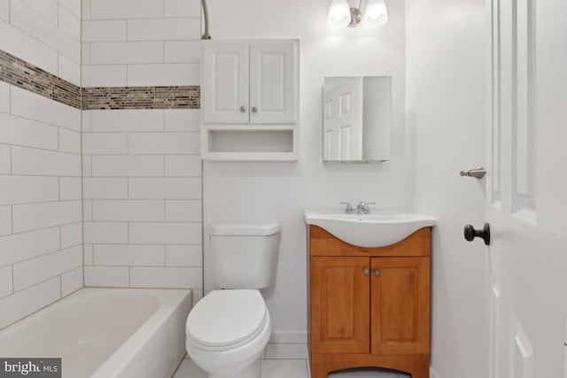 full bathroom with tiled shower / bath, vanity, and toilet