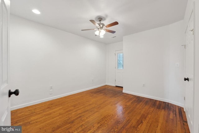 spare room featuring ceiling fan and dark hardwood / wood-style flooring