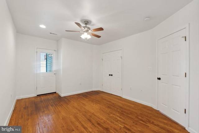 unfurnished room featuring ceiling fan and hardwood / wood-style floors