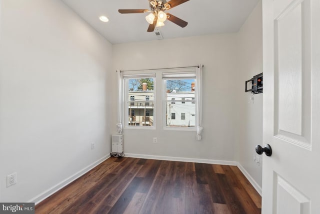 unfurnished room featuring ceiling fan and dark hardwood / wood-style floors