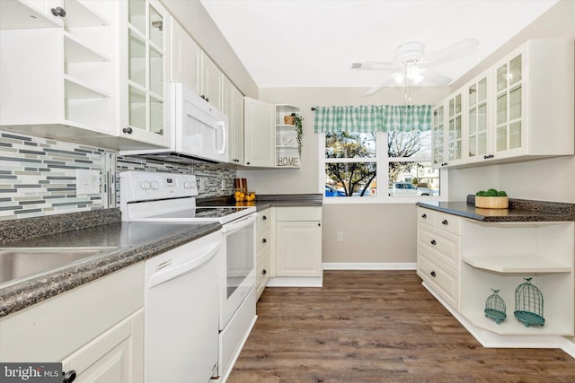 kitchen with white appliances, dark wood-type flooring, white cabinetry, and tasteful backsplash