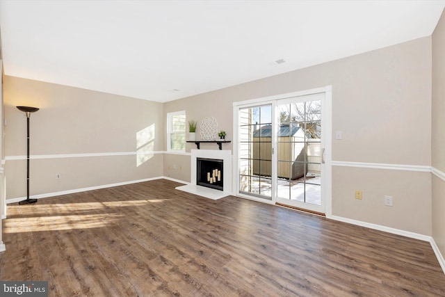 unfurnished living room featuring dark hardwood / wood-style flooring