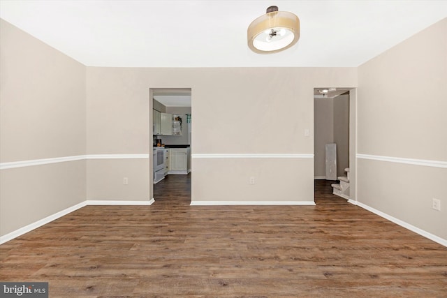 spare room featuring dark wood-type flooring