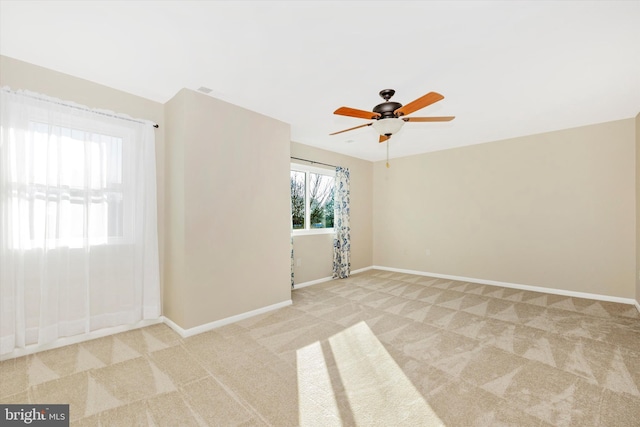 carpeted empty room with ceiling fan