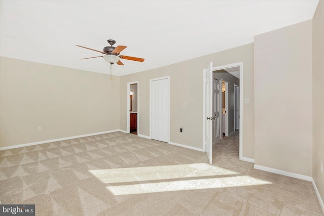 unfurnished bedroom featuring ceiling fan and light carpet