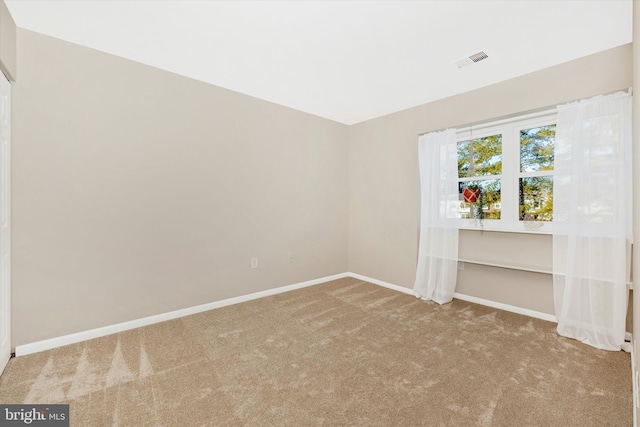 empty room featuring light carpet