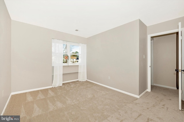 unfurnished bedroom featuring light colored carpet