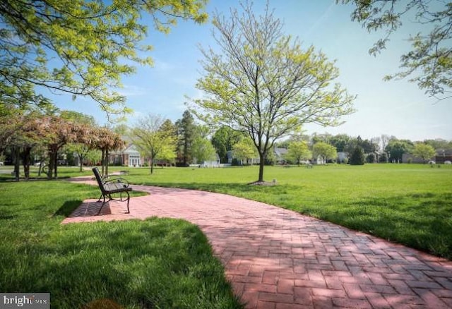 surrounding community featuring a lawn and a patio