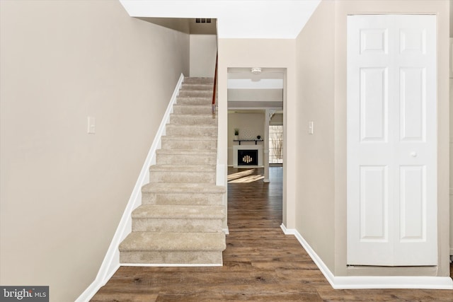 stairs featuring hardwood / wood-style flooring