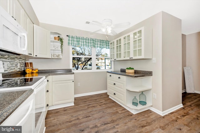 kitchen with white cabinetry, white appliances, ceiling fan, backsplash, and dark wood-type flooring