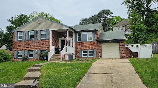 view of front facade with a garage and a front lawn