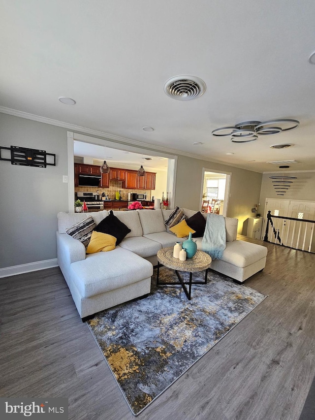 living room featuring dark hardwood / wood-style floors and ornamental molding