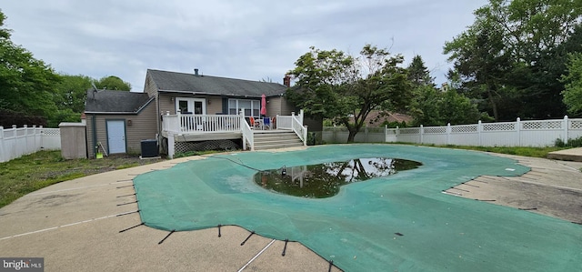 view of swimming pool featuring central AC and a wooden deck