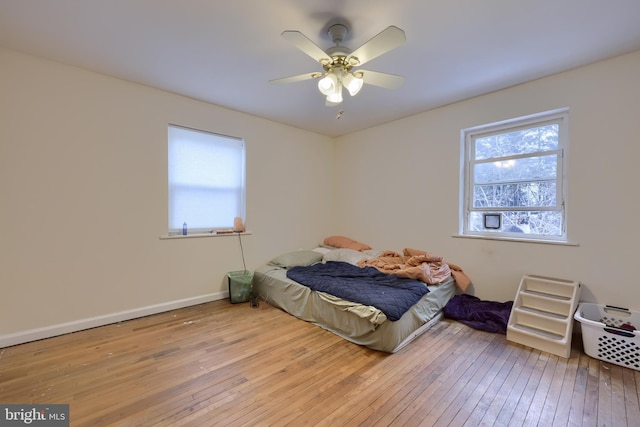 bedroom with ceiling fan and light hardwood / wood-style flooring