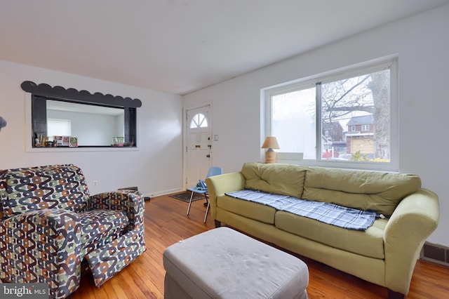 living room with plenty of natural light and hardwood / wood-style flooring