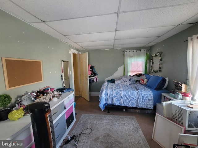 carpeted bedroom with a paneled ceiling