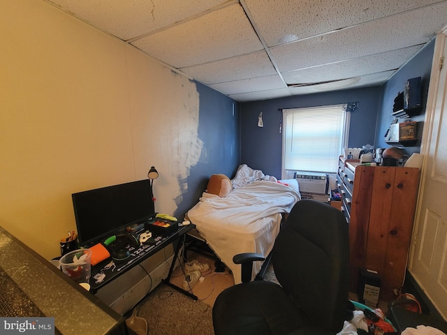 bedroom featuring a paneled ceiling and cooling unit