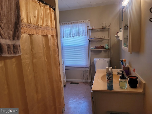 bathroom with toilet and vanity