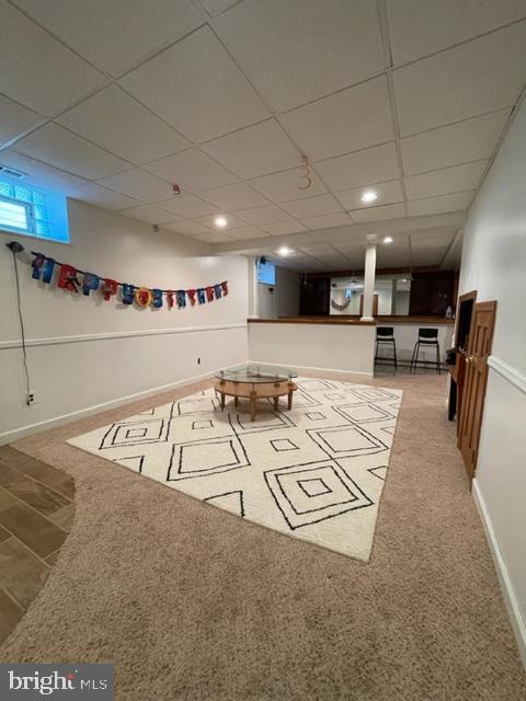 playroom with carpet and a drop ceiling