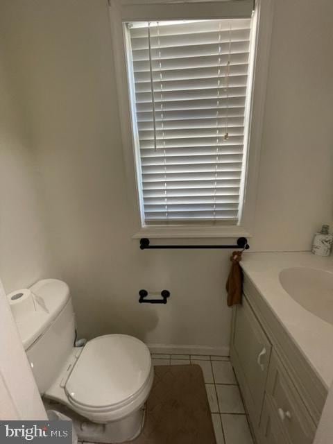 bathroom featuring tile patterned floors, vanity, and toilet