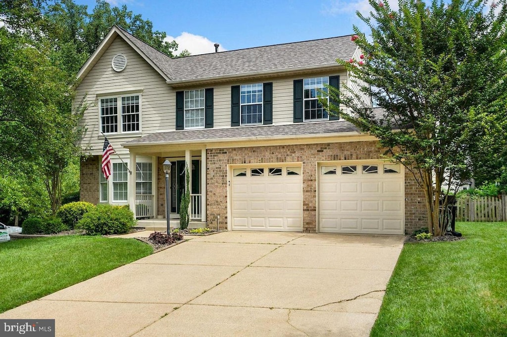 front of property with a garage and a front lawn