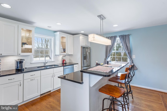 kitchen with sink, white cabinetry, and stainless steel appliances