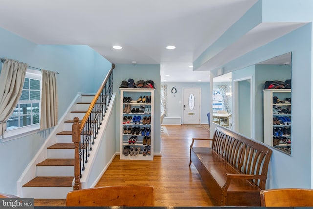 stairway featuring hardwood / wood-style flooring and plenty of natural light