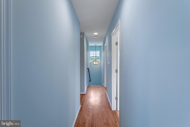 corridor with light hardwood / wood-style flooring