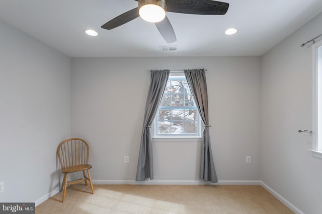 carpeted spare room with ceiling fan