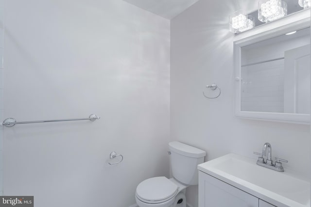 bathroom with toilet and vanity