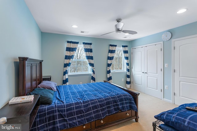 bedroom with ceiling fan and light colored carpet