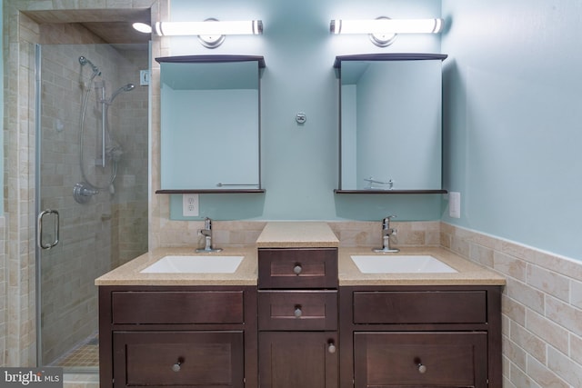 bathroom with vanity, walk in shower, and tile walls