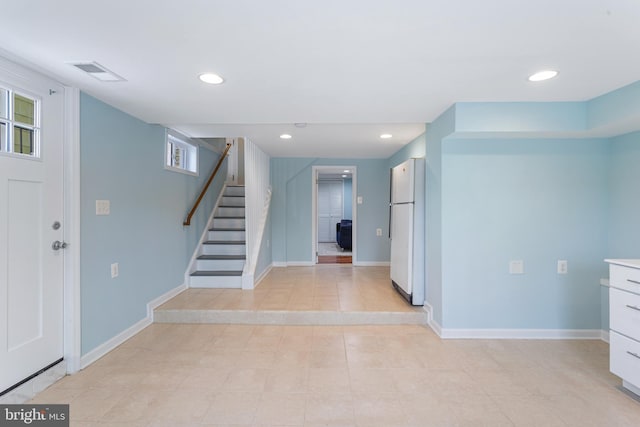 foyer entrance featuring light tile patterned flooring