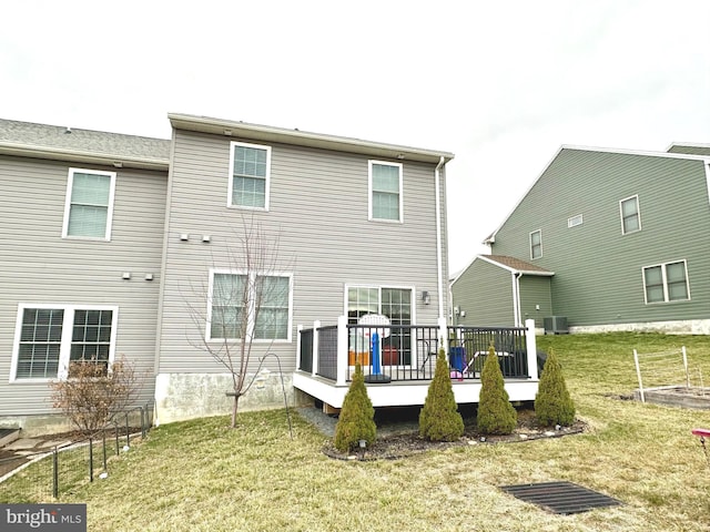 rear view of house featuring cooling unit, a yard, and a wooden deck