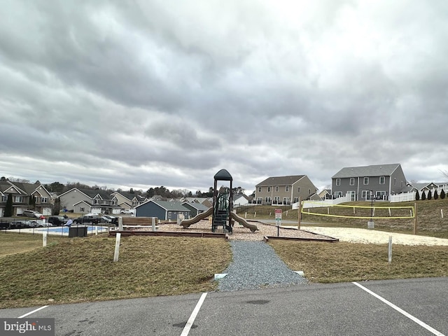 community play area featuring a residential view and volleyball court