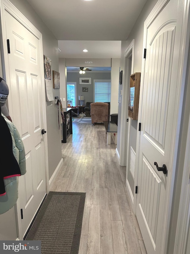 hall featuring baseboards and light wood-style floors