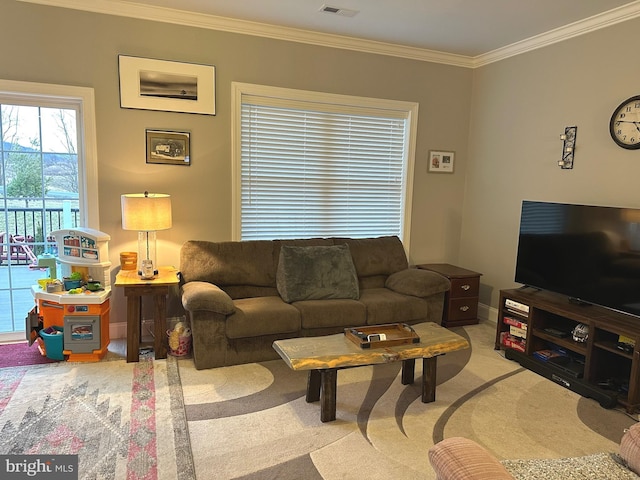 carpeted living room with ornamental molding, visible vents, and baseboards