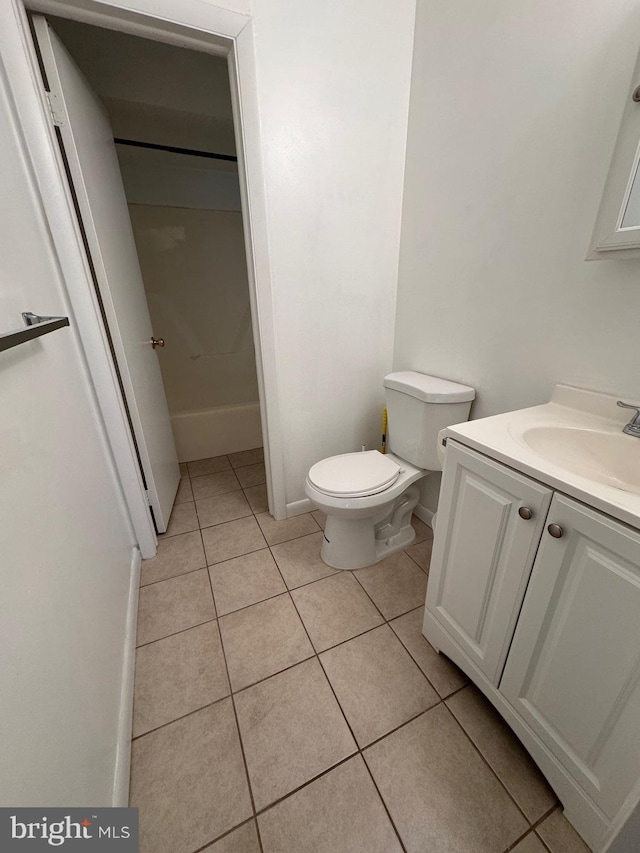 bathroom featuring tile patterned floors, vanity, and toilet