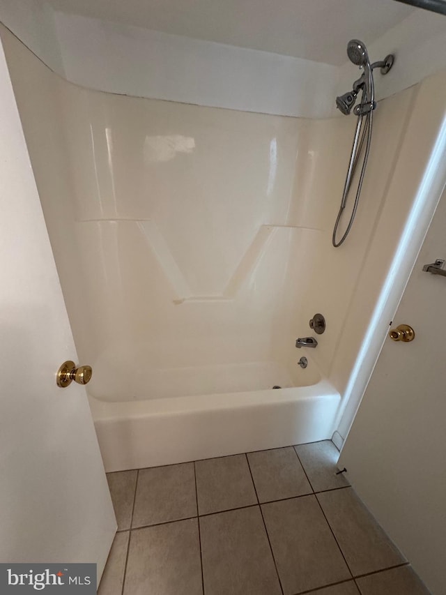 bathroom featuring tile patterned flooring and washtub / shower combination