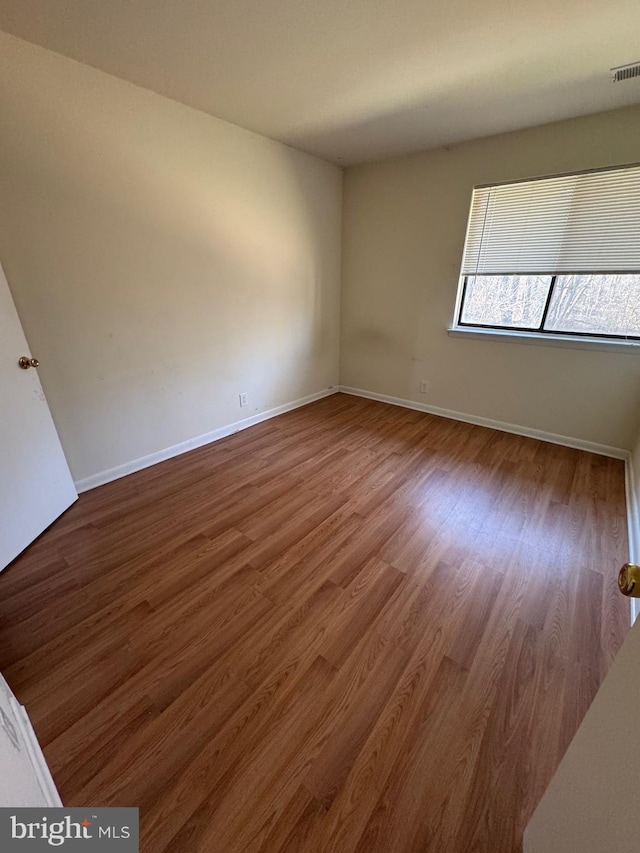 unfurnished room with hardwood / wood-style floors