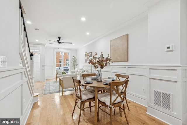 dining room with ceiling fan, light hardwood / wood-style flooring, and ornamental molding