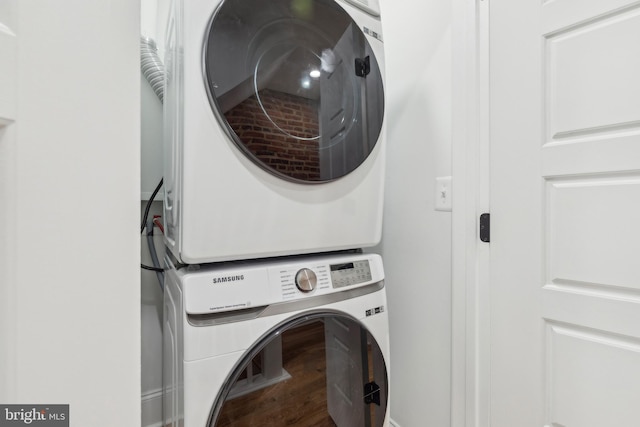 clothes washing area featuring stacked washer and dryer