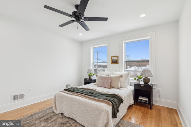 bedroom with ceiling fan and wood-type flooring