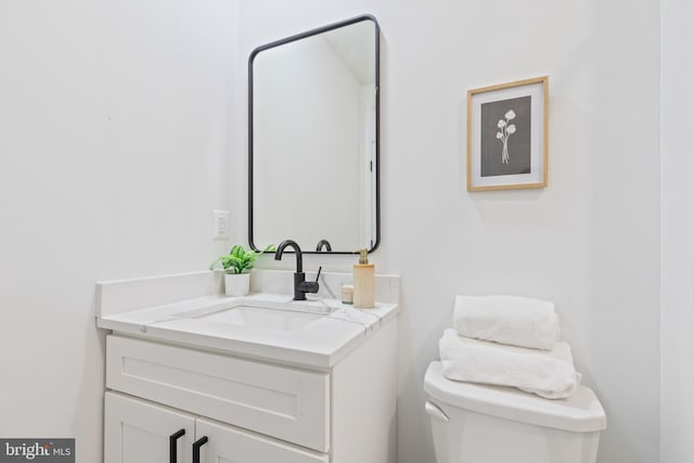 bathroom featuring toilet and vanity