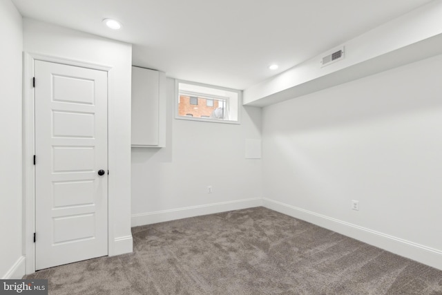 basement featuring light colored carpet