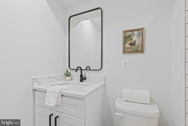 bathroom with toilet and vanity