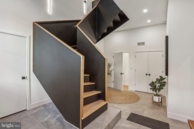 entryway featuring a towering ceiling