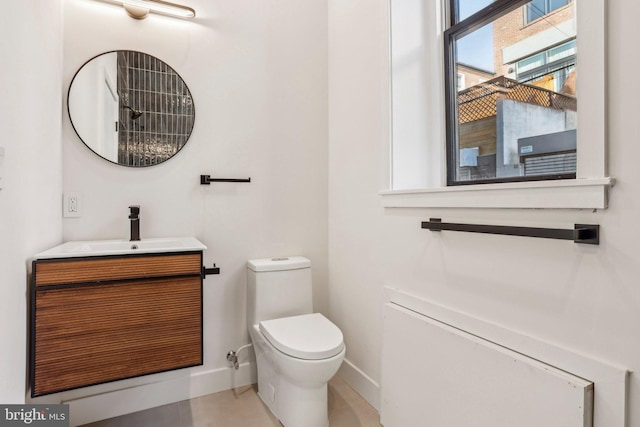 bathroom featuring toilet and vanity