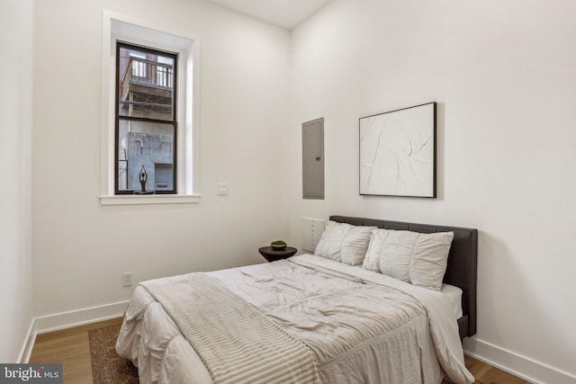 bedroom featuring hardwood / wood-style floors and electric panel